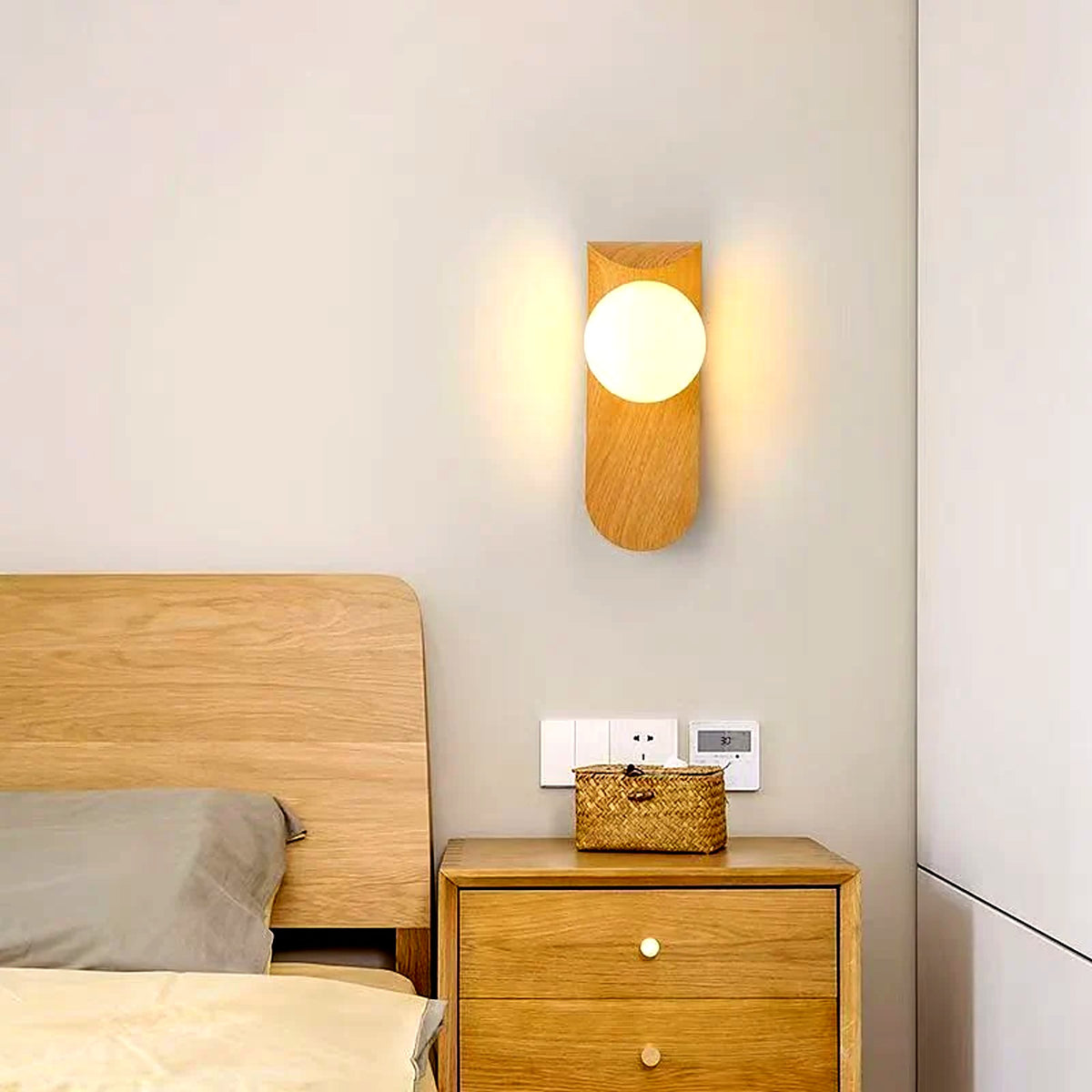 Applique murale bois naturel au-dessus d'une table de chevet