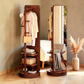 Miroir sur pied pivotant en noyer, côté portant et côté miroir, dans un dressing lumineux