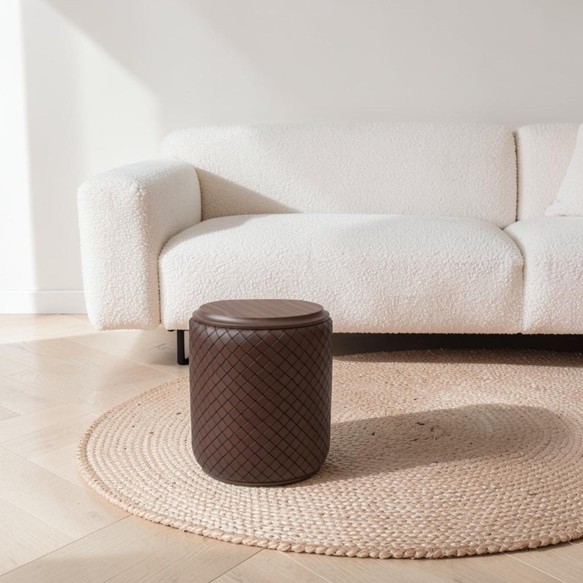 Tabouret rond tressé café devant un canapé bouclette