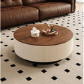 Table basse ronde AUBRYNE plateau noyer et caisson crème, dans un salon